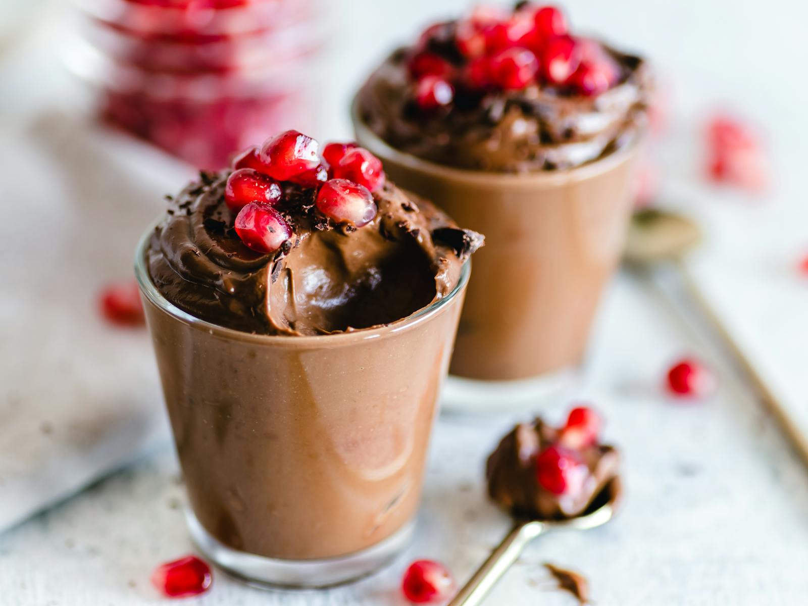 Luscious chocolate mousse topped with fresh pomegranate seeds, perfect for dessert lovers.